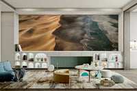 A wall mural of a desert next to the coast.

