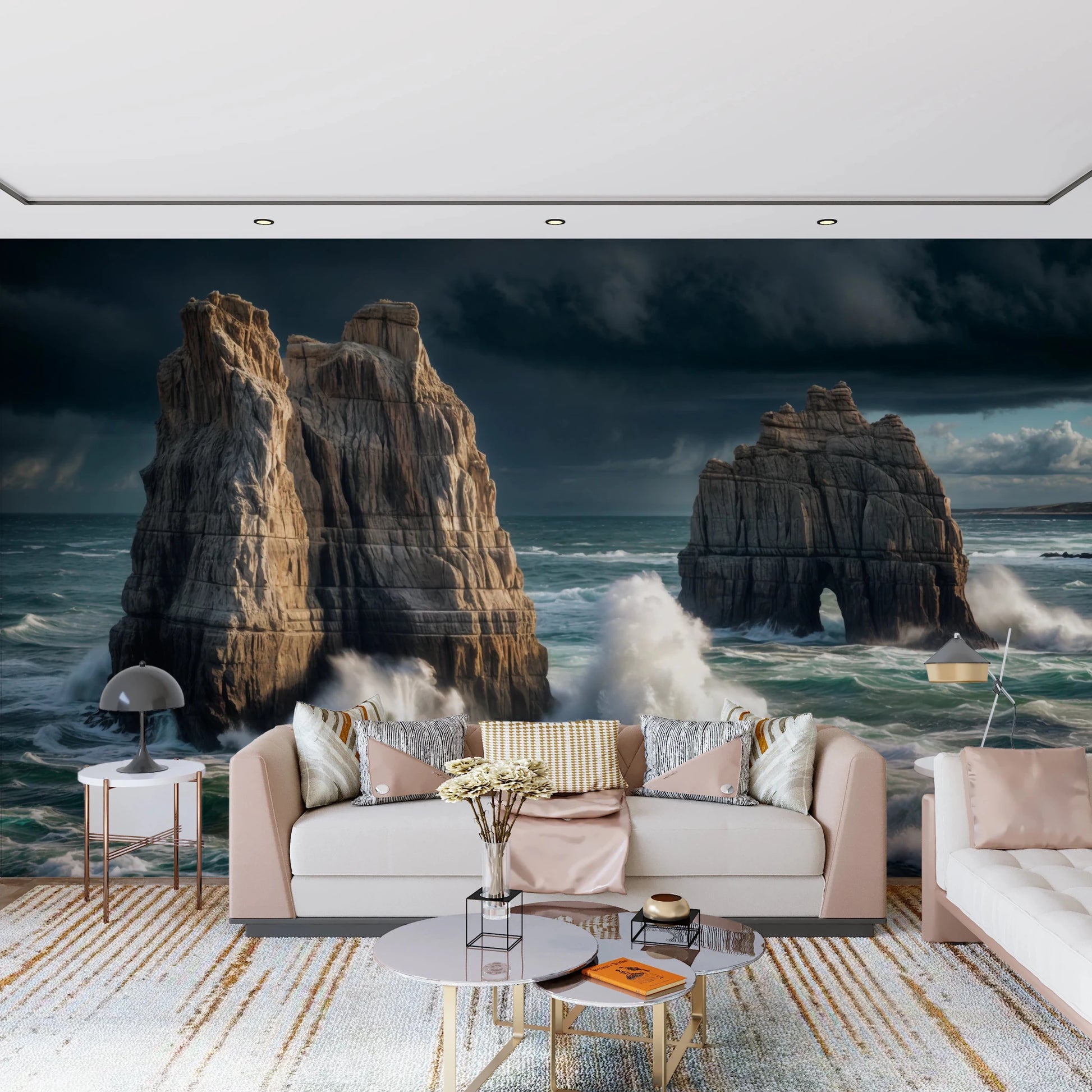 Coastal Giants wallpaper mural behind a blush pink sofa with gold-accented coffee tables in a living room
