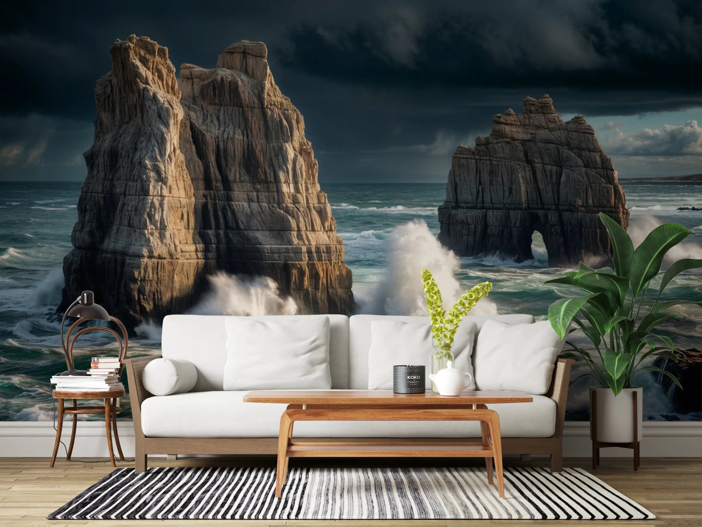 Coastal Giants wallpaper mural behind a white wood-frame sofa with a striped rug and tall potted plant