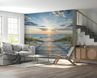 Coastal Path Serenity wall mural of a beach boardwalk at dusk behind a grey sofa beside a wood staircase