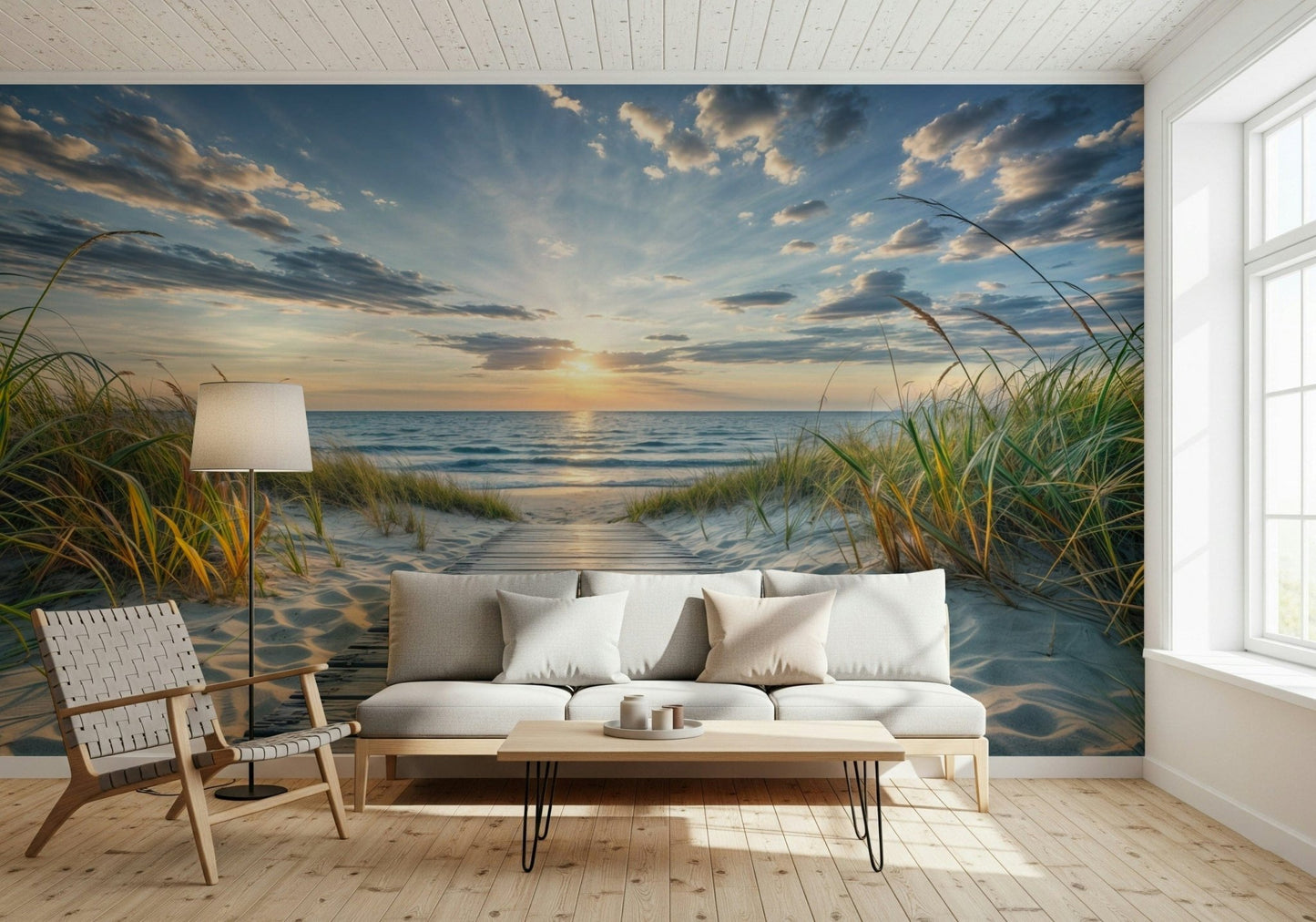 Coastal Path Serenity wall mural of dune grass and sea at dusk behind a white sofa and woven lounge chair