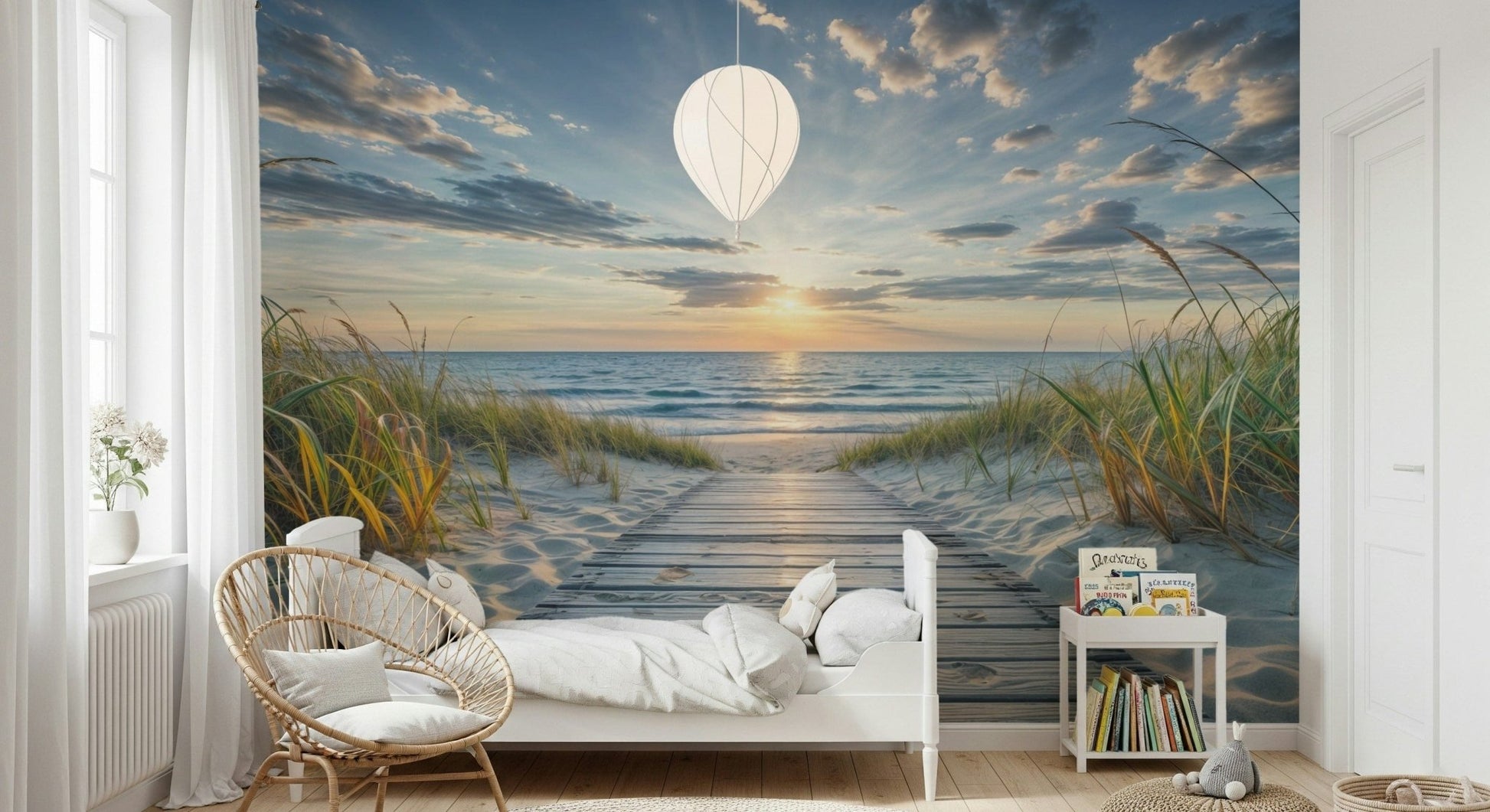 Coastal Path Serenity wall mural of a wooden path to the ocean behind a white bed and balloon pendant in a child's room