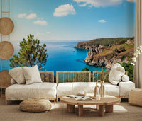 Scenic coastline mural with green color accents, subtle mountain wallpaper backdrop