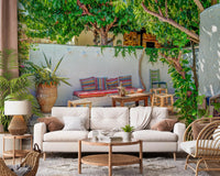 Lush green leaves overhanging a Colorful Backyard Patio Wall Mural scene.