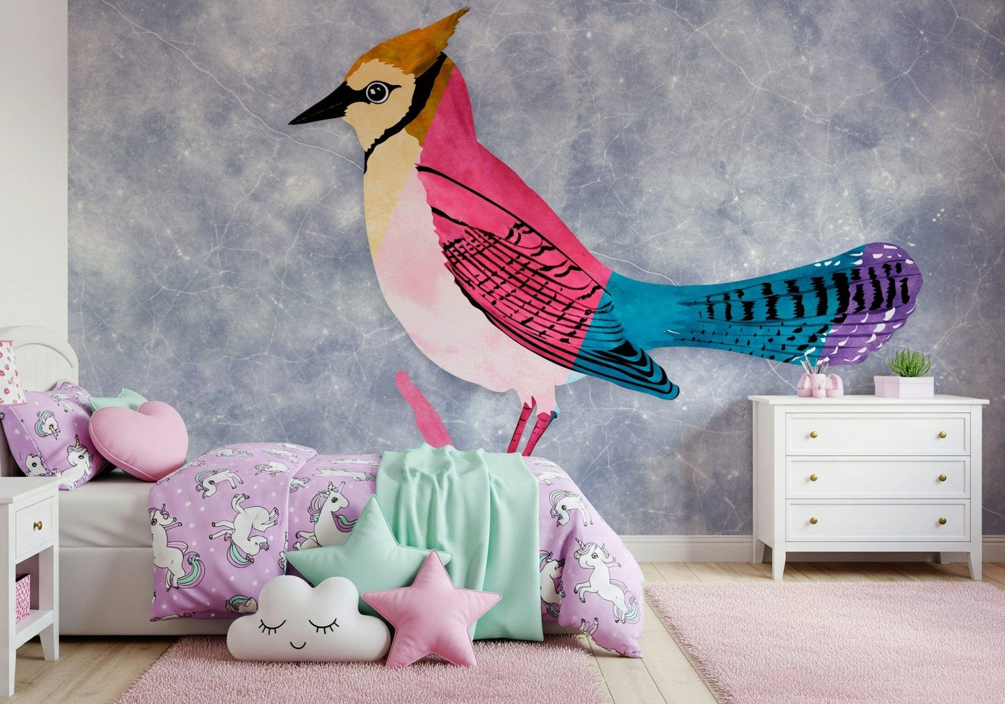 Colorful Jay wall mural, a pink bird on blue-grey behind purple unicorn bedding in a girls bedroom