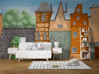 Small Painted City wallpaper mural above a white daybed topped with owl and bunny plush toys in a kids room