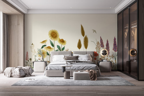 Colorful Sunflower Field wallpaper mural with yellow sunflowers, pampas grass and lupines behind a grey upholstered bed in a bedroom