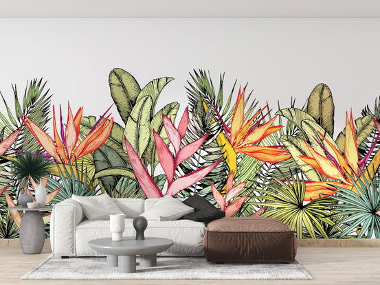 Colorful Tropical Palm Leaves Flowers wallpaper mural behind a white sofa and leather ottoman in a living room