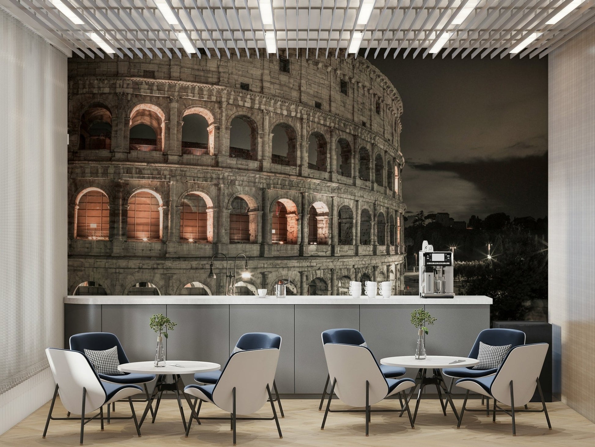 The image shows a full wall with the Colosseum lit up after dark.

