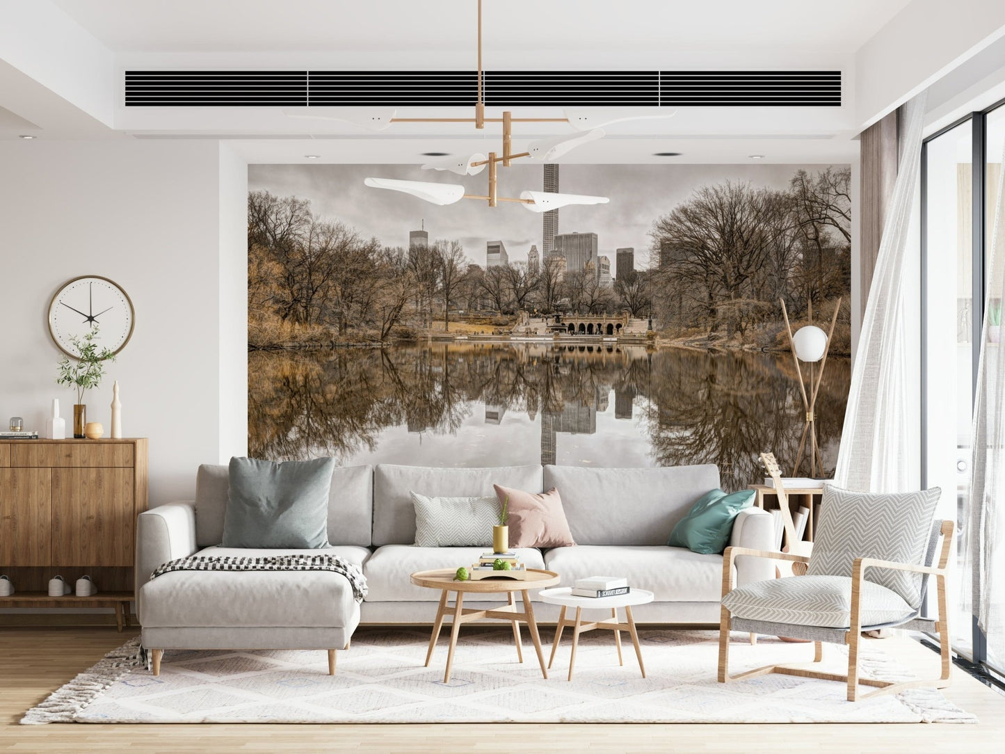Contrast of Worlds mural behind a grey sofa and chaise with a brass sputnik chandelier and wall clock