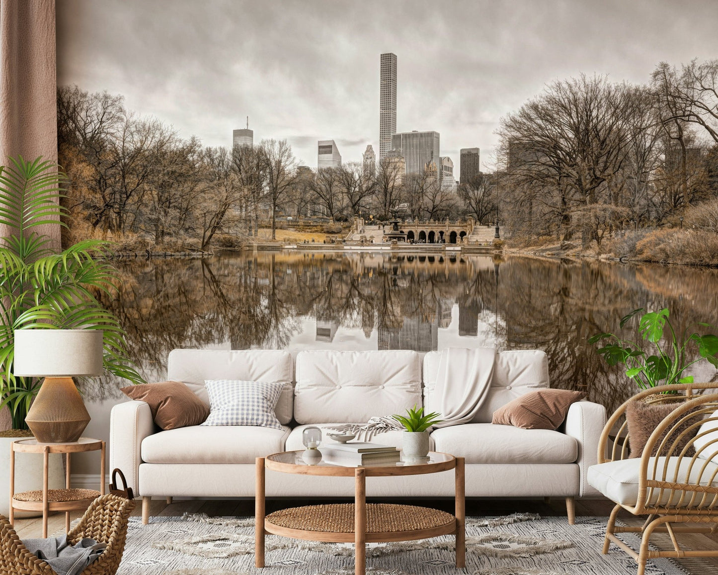 Contrast of Worlds mural of a Central Park lake and skyline above a white sofa with woven baskets and a palm