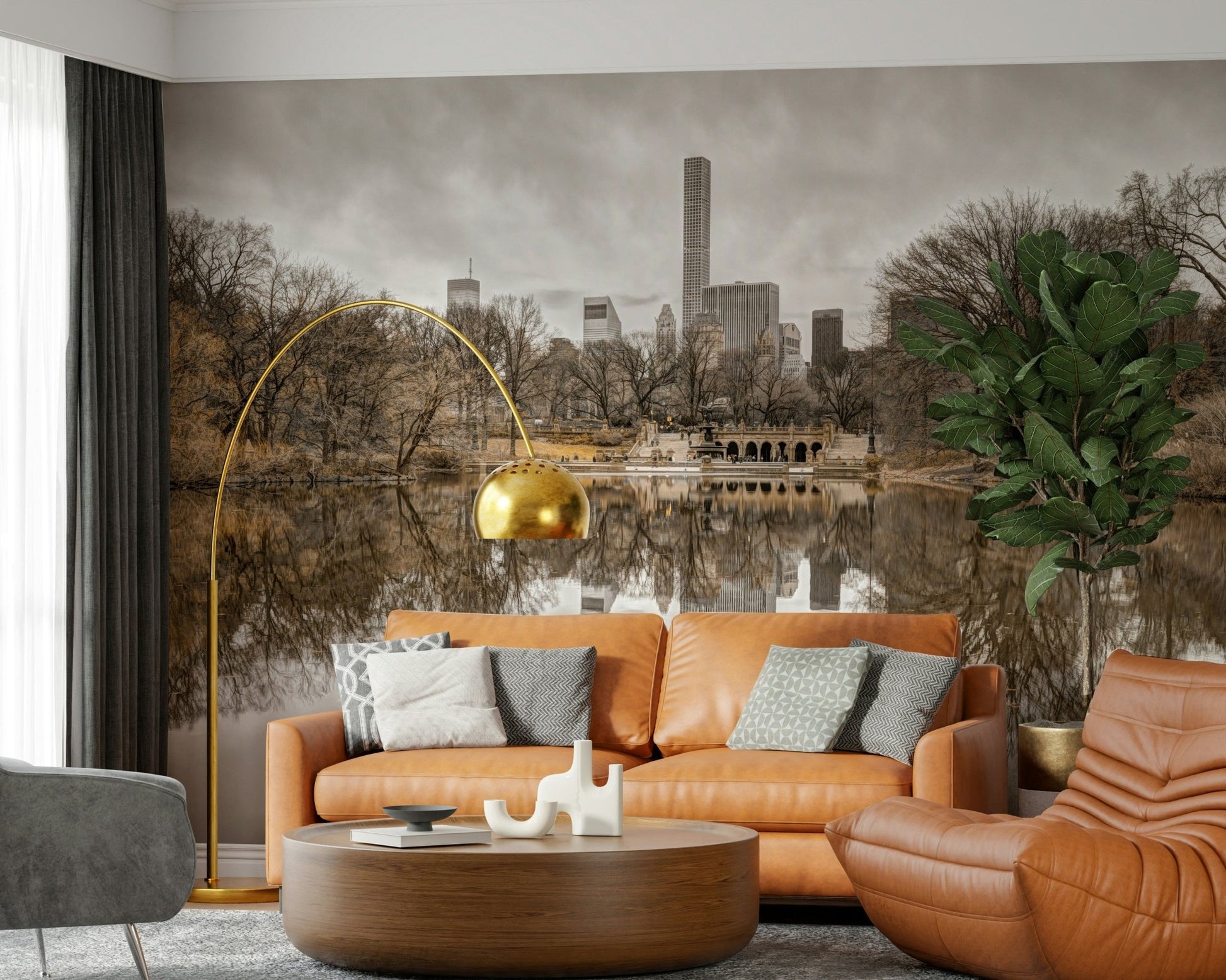 Contrast of Worlds mural with a caramel leather sofa, gold arc floor lamp and fiddle-leaf fig in a living room