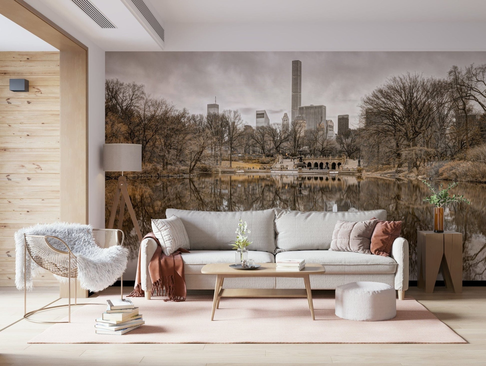 Contrast of Worlds mural with a white sofa, fluffy sheepskin chair and tripod lamp on a soft pink rug