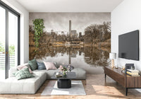 Contrast of Worlds mural above a grey L-shaped sectional with pink and green pillows beside a mounted TV