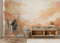 Soft sunset tones in a contemporary apartment bedroom featuring cloud art decor.