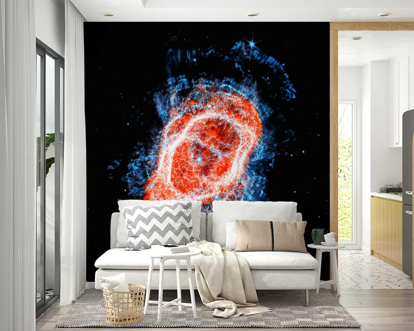 Cosmic Bloom wall mural of a red and blue nebula behind a white sofa with a chevron cushion near a kitchen