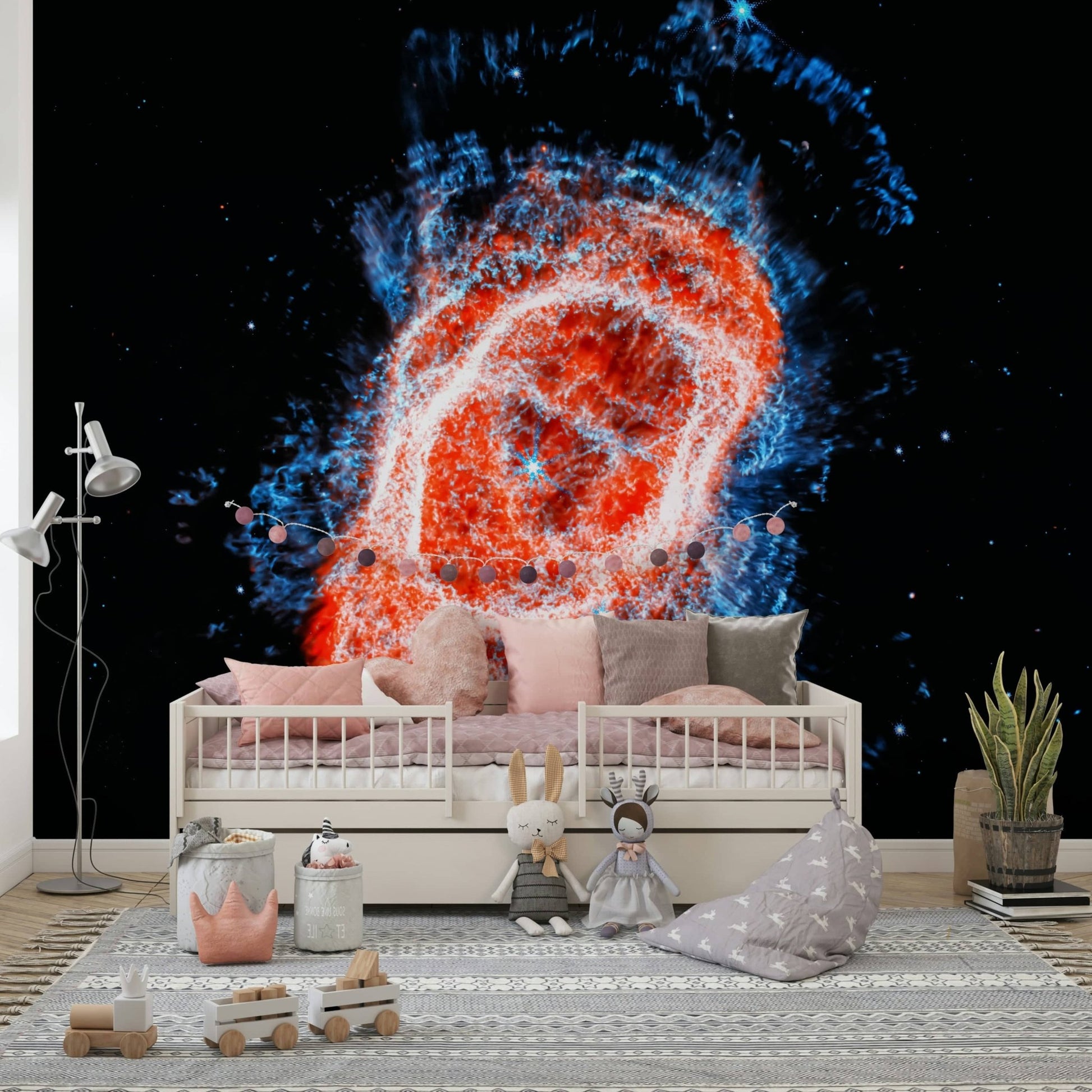 Cosmic Bloom wall mural of a red ring nebula behind a white daybed with pink cushions and plush toys in a kids room