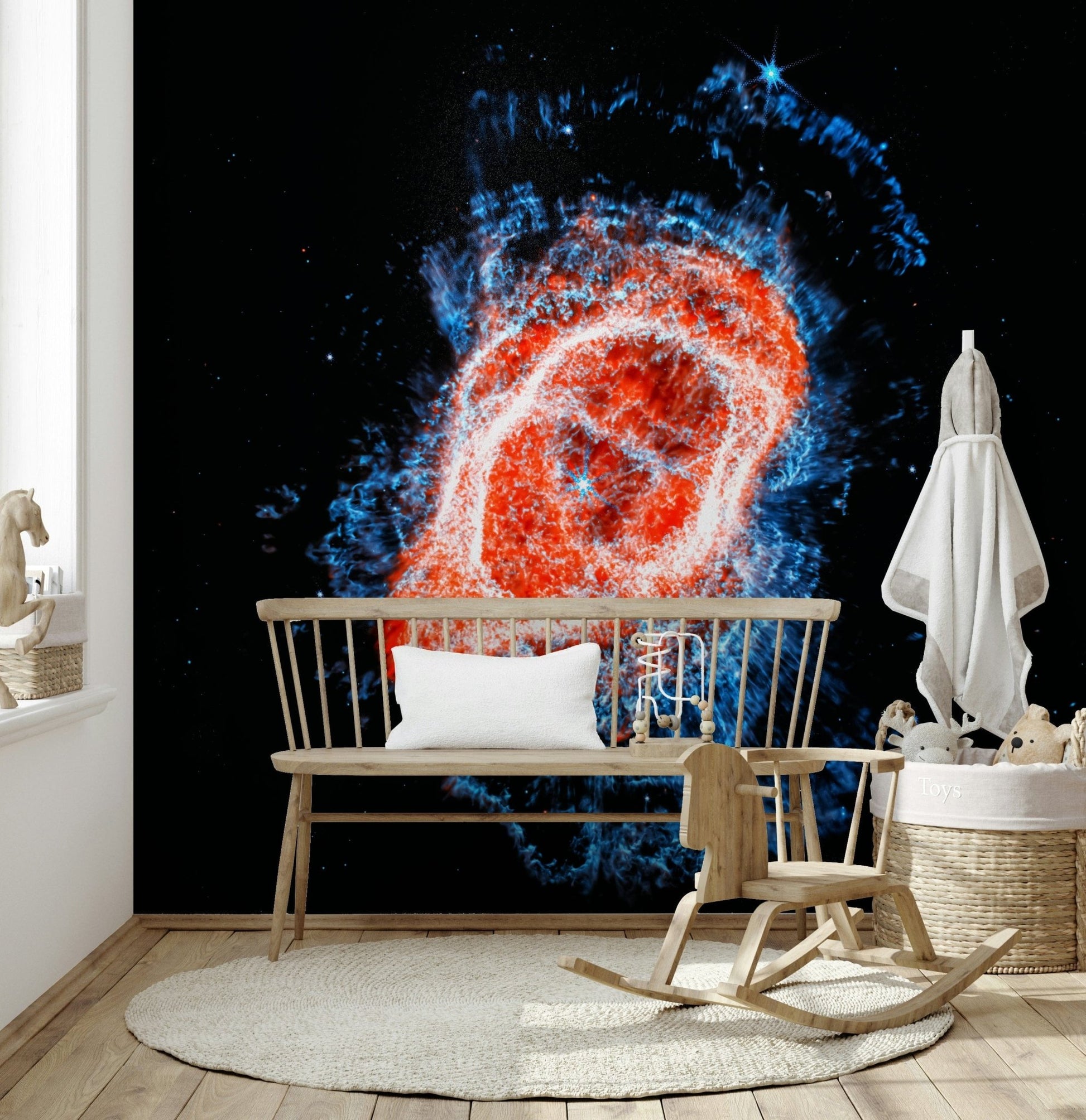 Cosmic Bloom wall mural of a fiery ring nebula behind a wood spindle bench and rocking chair in a nursery