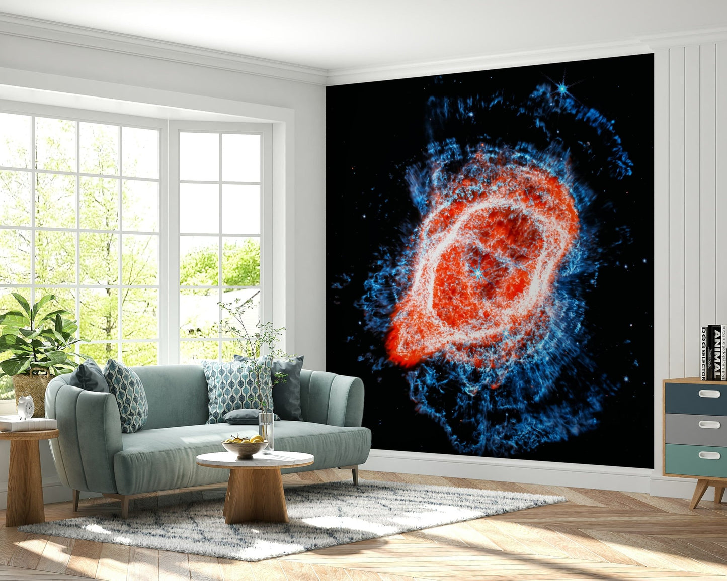 Cosmic Bloom wall mural of red and electric blue cosmic gas behind a sage green sofa and round wood table