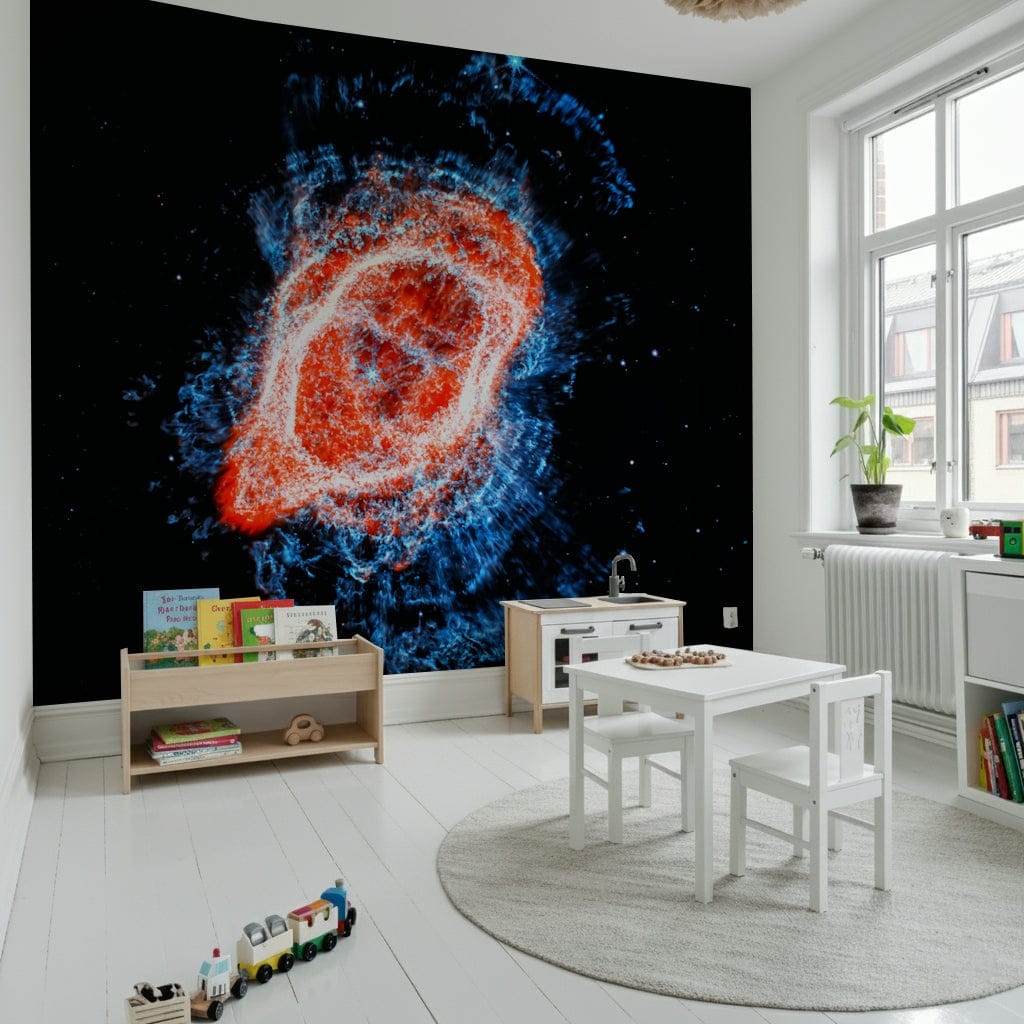 Cosmic Bloom wall mural of a red and blue galaxy behind a white kids table and toy train in a bright playroom