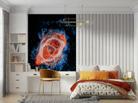 Cosmic Bloom wall mural of a fiery nebula behind a bed with mustard cushions and a gold desk chair in a bedroom