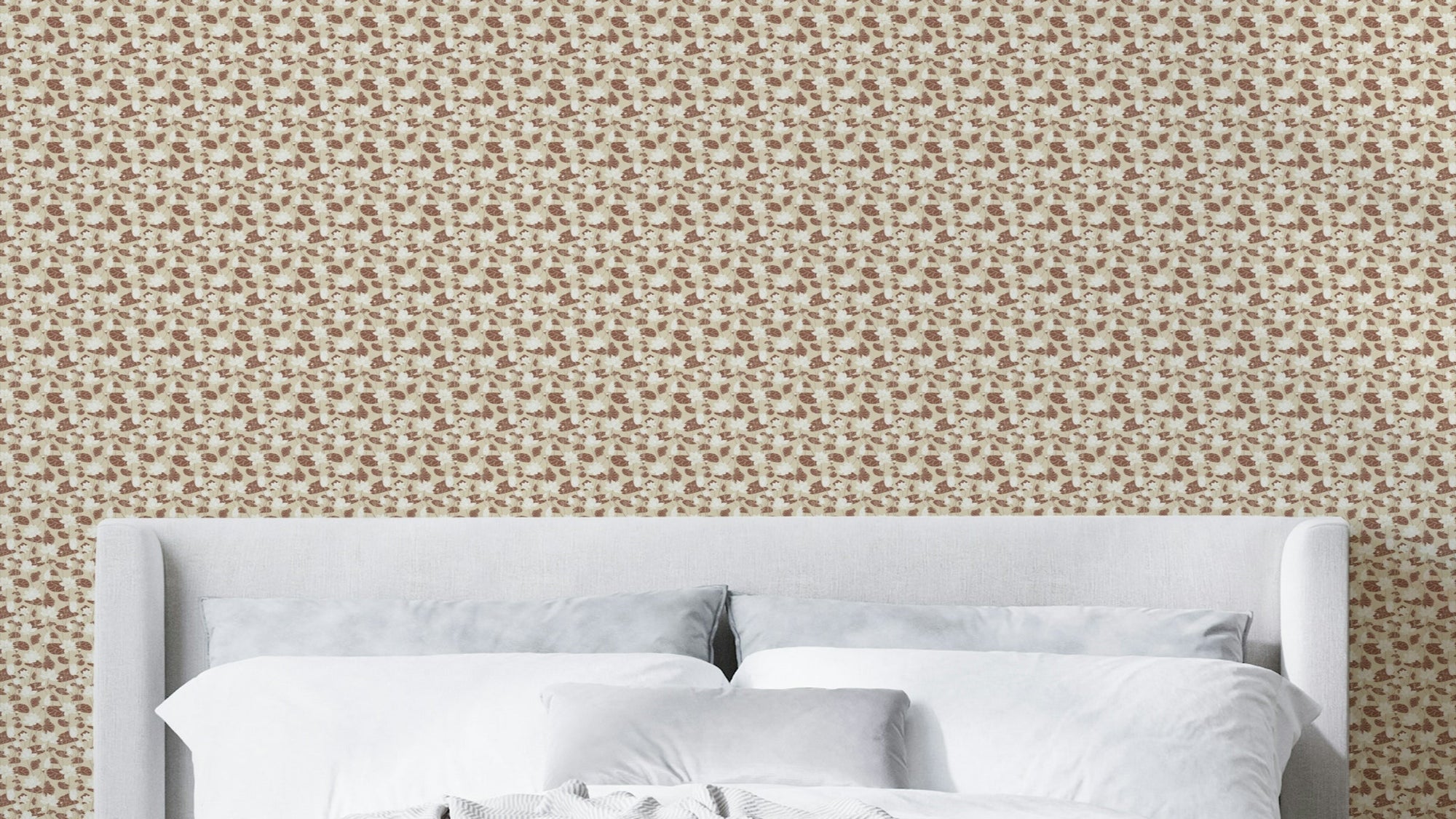 Cozy Cream Lotus Flowers wallpaper in tan ditsy floral behind a gray upholstered headboard and white bedding