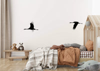 A graceful subtle bird wall mural in cool, natural tones.

