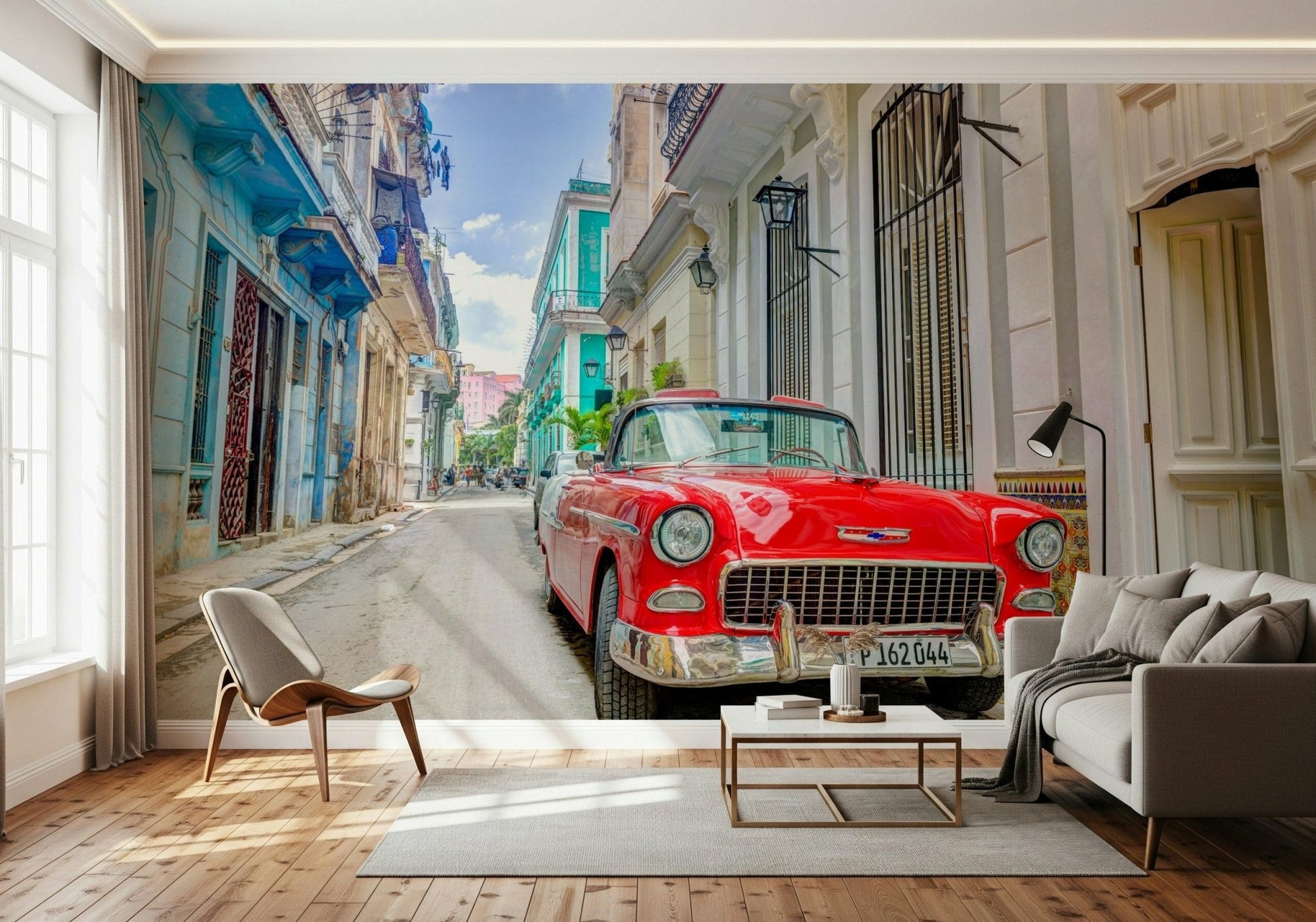 Cuban Classics wallpaper mural of a red vintage car behind a grey sofa and shell chair in a living room