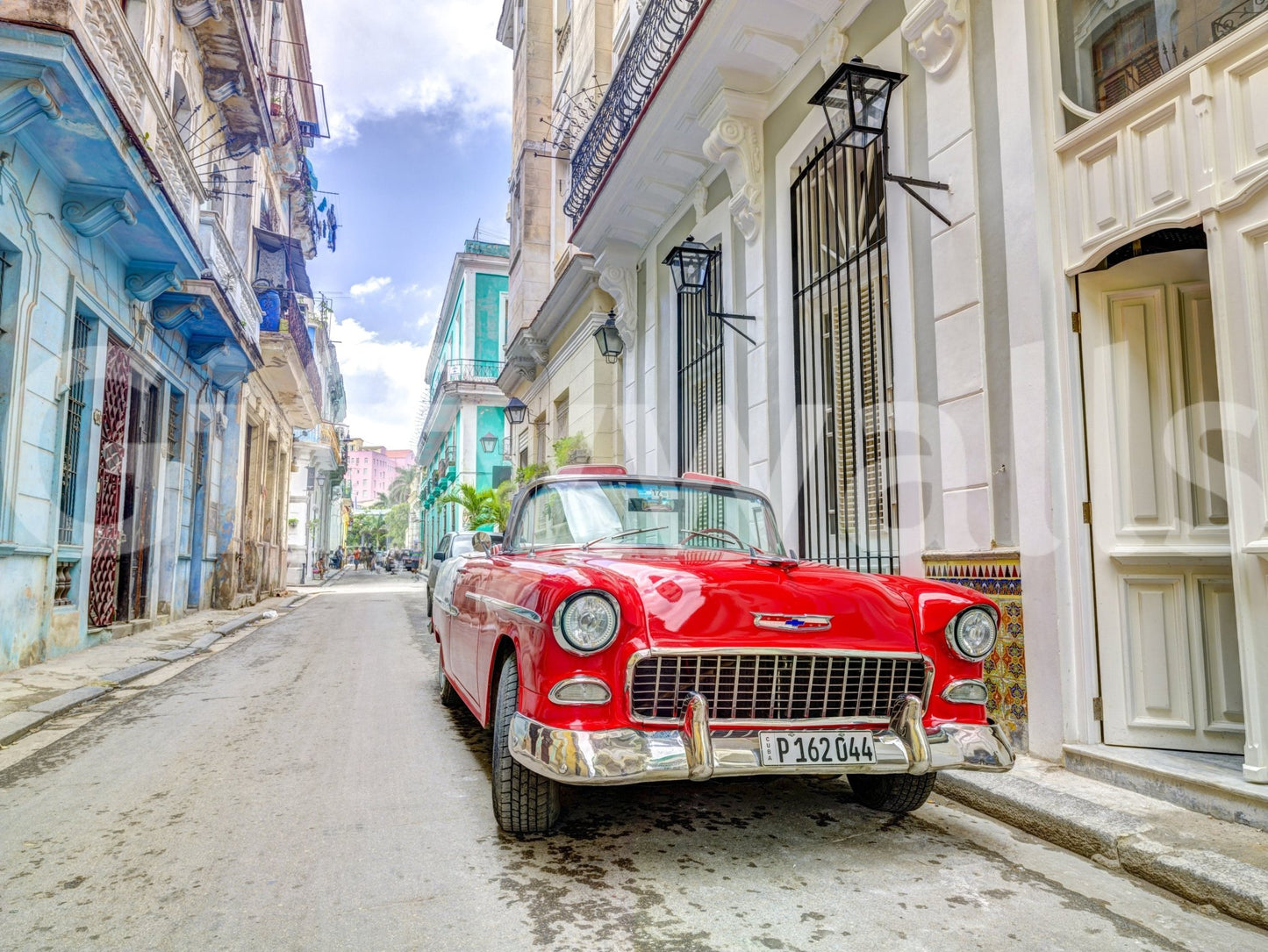 Cuban Classics shown as a full-wall mural, a red vintage convertible parked on a colourful Havana street