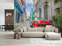Cuban Classics wallpaper mural of a red vintage car on a Havana street behind a beige sofa in a living room