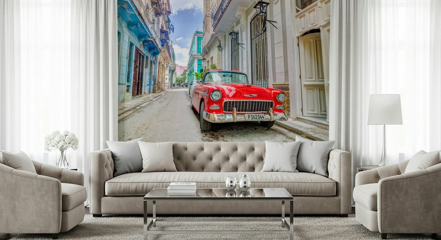 Cuban Classics wallpaper mural of a red vintage car behind a beige tufted sofa and armchairs in a living room