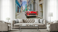 Cuban Classics wallpaper mural of a red vintage car behind a beige tufted sofa and armchairs in a living room
