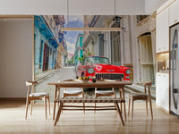 Cuban Classics wallpaper mural of a red vintage car behind a wood dining table and bench in a dining room