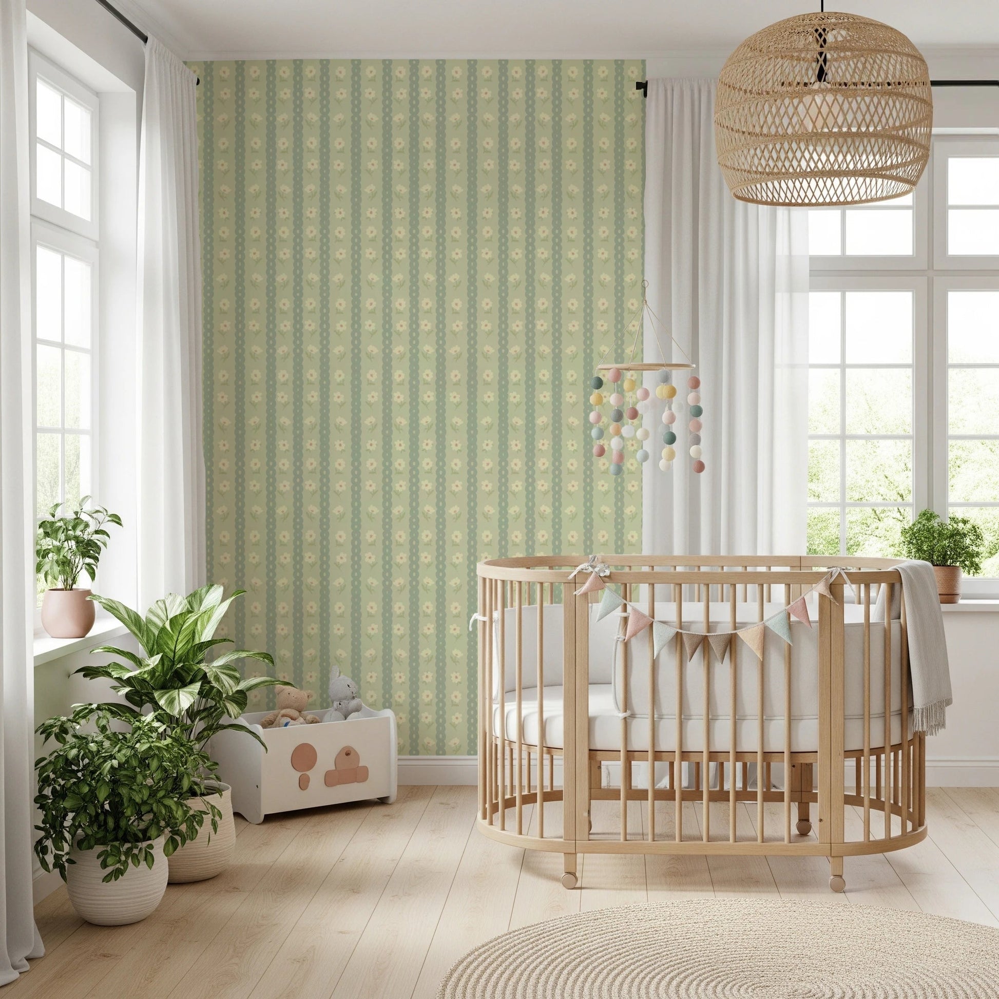 Daisy Chain Delight wallpaper mural in a nursery behind a wood crib with a pompom mobile and leafy plants