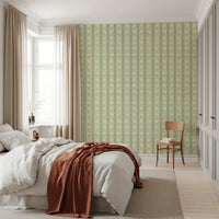 Daisy Chain Delight wallpaper mural in a bedroom with a white bed and rust throw, green daisy stripes