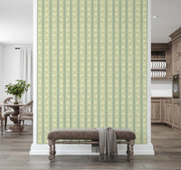 Daisy Chain Delight wallpaper mural on a divider wall above a brown velvet bench, sage green daisy stripes