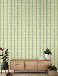 Daisy Chain Delight wallpaper mural behind a walnut credenza with a rubber plant and fiddle leaf fig, green daisies