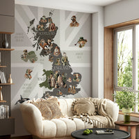 Dapper Creatures of Britain wallpaper mural of a UK animal map above a cream sofa with pompom pillows
