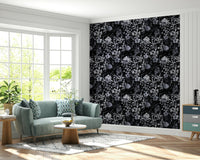A dining room decorated with a dark floral mural

