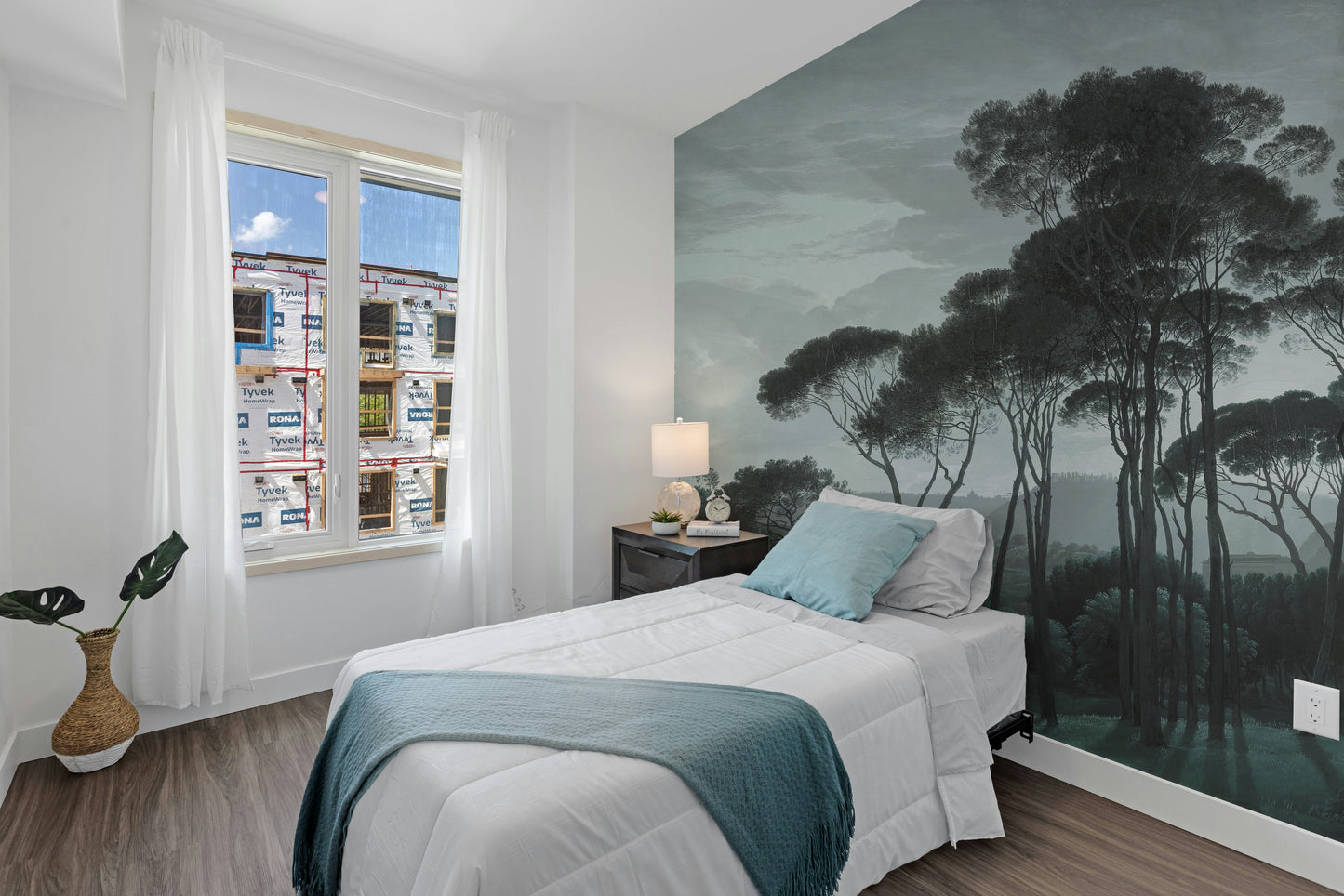 Dark Green Misty Forest Tree wallpaper mural styled as a feature wall behind a dining table and chairs in green tones