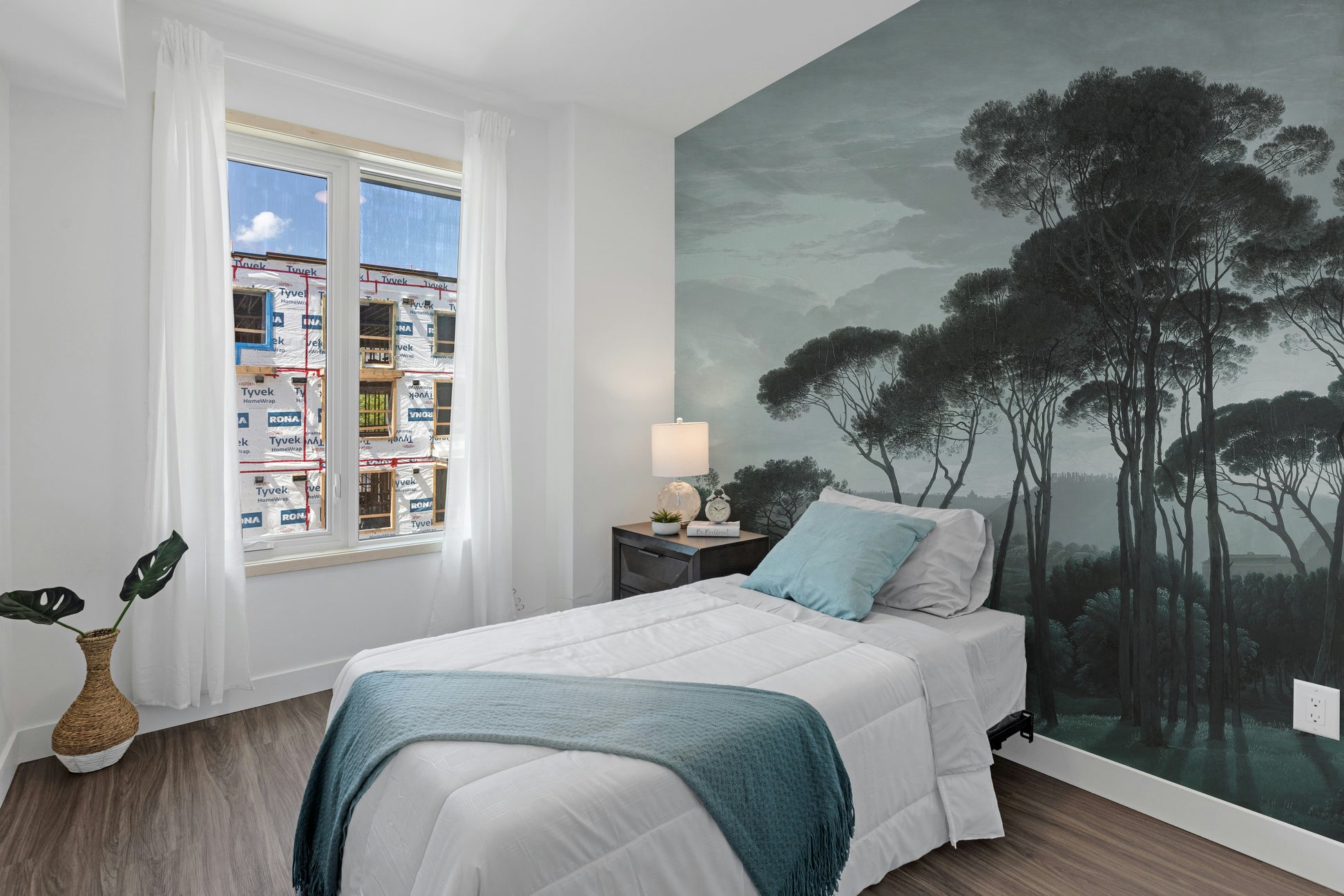 Dark Green Misty Forest Tree wallpaper mural styled as a feature wall behind a dining table and chairs in green tones