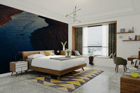 A bedroom with the moody mural behind the headboard.

