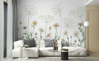 Dazzling Daisies wallpaper of white daisies and wildflowers behind a white sectional sofa in a bright living room