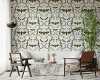 In a lounge, the Death's-Head Hawkmoth Garden Wallpaper reads in green and white.