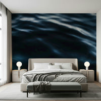Wall mural depicting dynamic ocean waves in navy and teal for a coastal vibe.