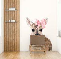 Beautiful deer with a bow wall art mural for rustic spaces.

