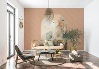 Delicate Bloom Frame wallpaper mural behind a cane daybed sofa with an olive tree on a terracotta tiled living room floor
