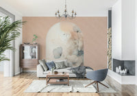 Delicate Bloom Frame wallpaper mural behind a grey sofa with a blue swivel chair and glass cabinet under a chandelier