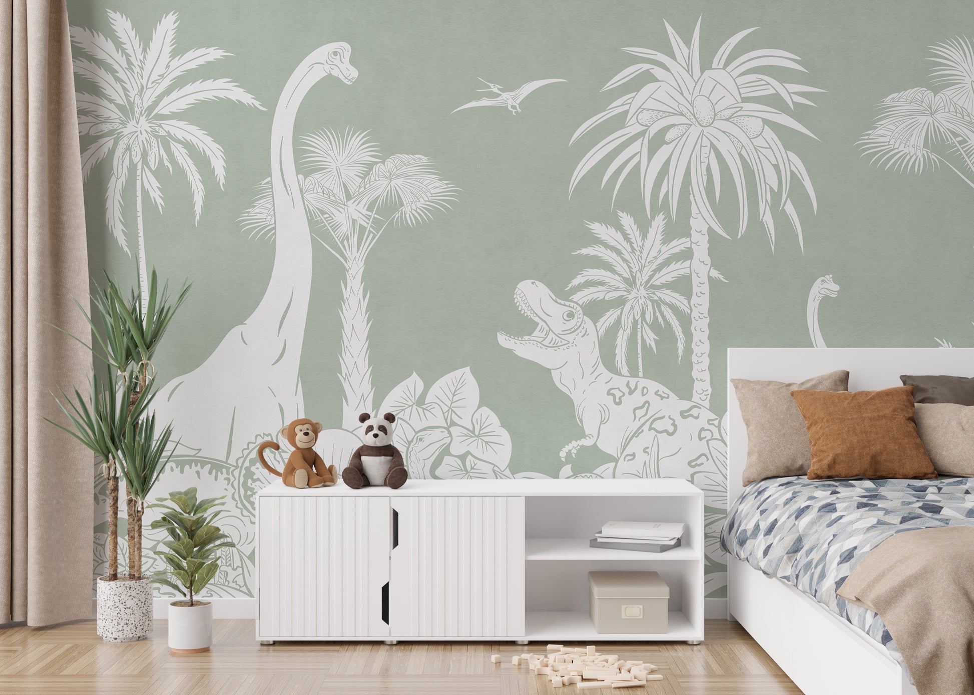 Monochrome Dino Green wallpaper mural beside a white bed with blue bedding and a sideboard topped with plush toys