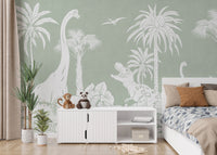 Monochrome Dino Green wallpaper mural beside a white bed with blue bedding and a sideboard topped with plush toys